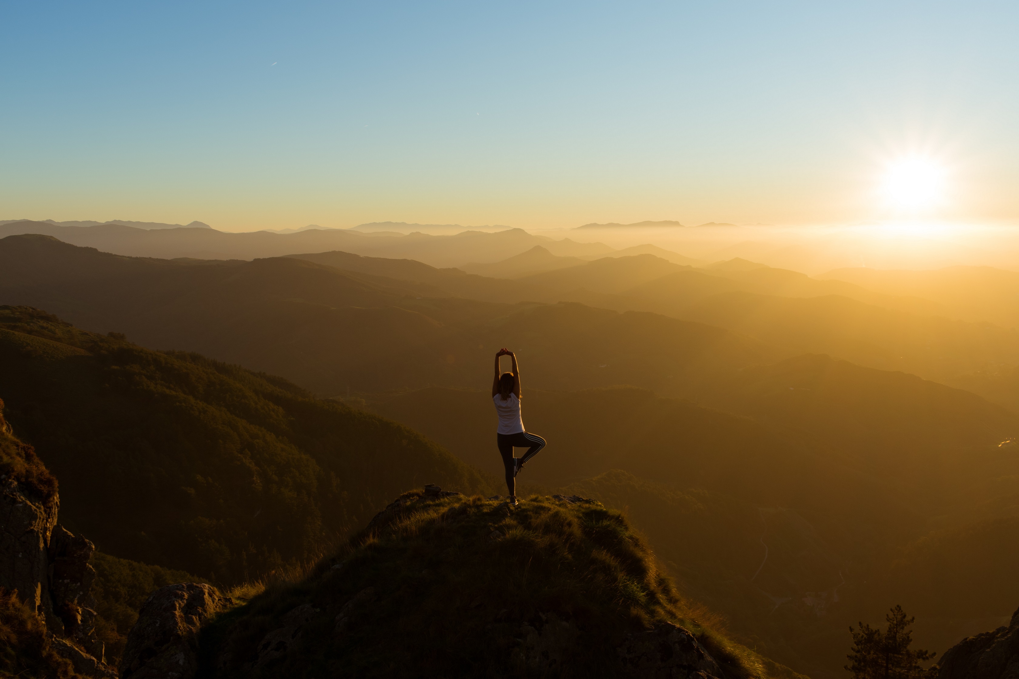 woman streatching on mountain