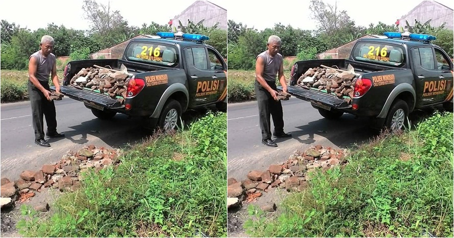 Polisi ini punya 'kerjaan sampingan' singkirkan batu di jalan, mulia!