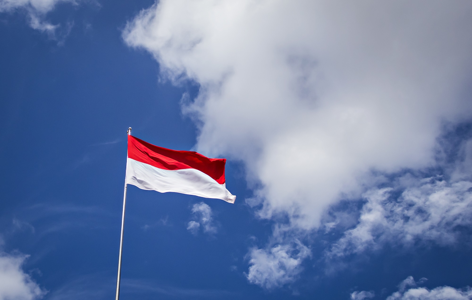 A Teacher Fixes An Upside-Down Indonesian Flag In Thailand