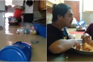 Terjebak banjir, cara makan pemuda ini jadi sorotan