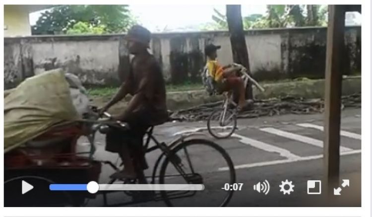  Anak  ini naik sepeda  tanpa roda depan di jalanan Surabaya  