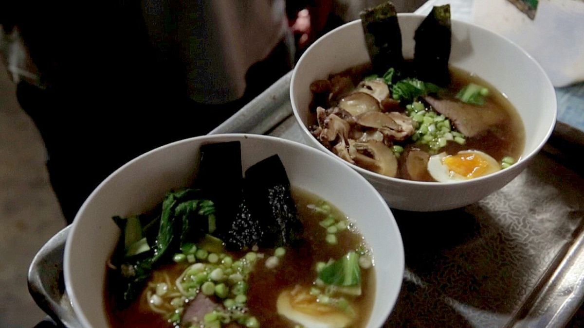 Jogja street food scene with ramen stalls and customers