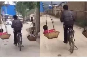 Hebatnya pria ini, pikul dua anak pakai keranjang sambil gowes sepeda