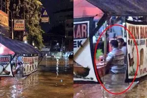 Potret orang makan dengan tenang di tengah banjir ini tuai kontroversi