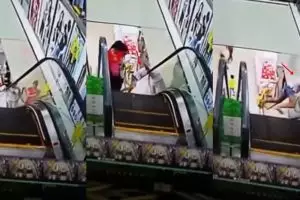 Melihat ke bawah saat naik eskalator, leher cewek ini nyaris patah
