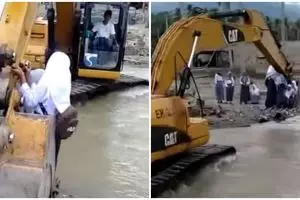 Demi ikut ujian, pelajar Sigi nekat seberangi sungai pakai alat berat