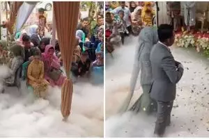 Pengantin berjalan ke pelaminan pakai efek asap, kok kepikiran ya?