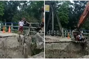 Momen bocah SD ingin berangkat sekolah lewat jembatan putus, dibantu ekskavator untuk menyeberang